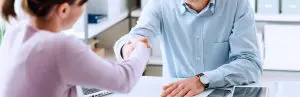 Two people waving hand in an office, healthy client relationships