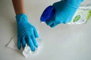Person wiping down a counter: questions to ask a commercial cleaning service