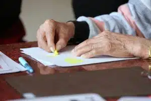 Hands of an older woman doing artwork