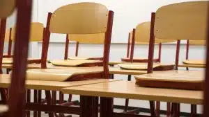 Chairs stacked on top of desks in a school classroom: how to clean a school classroom