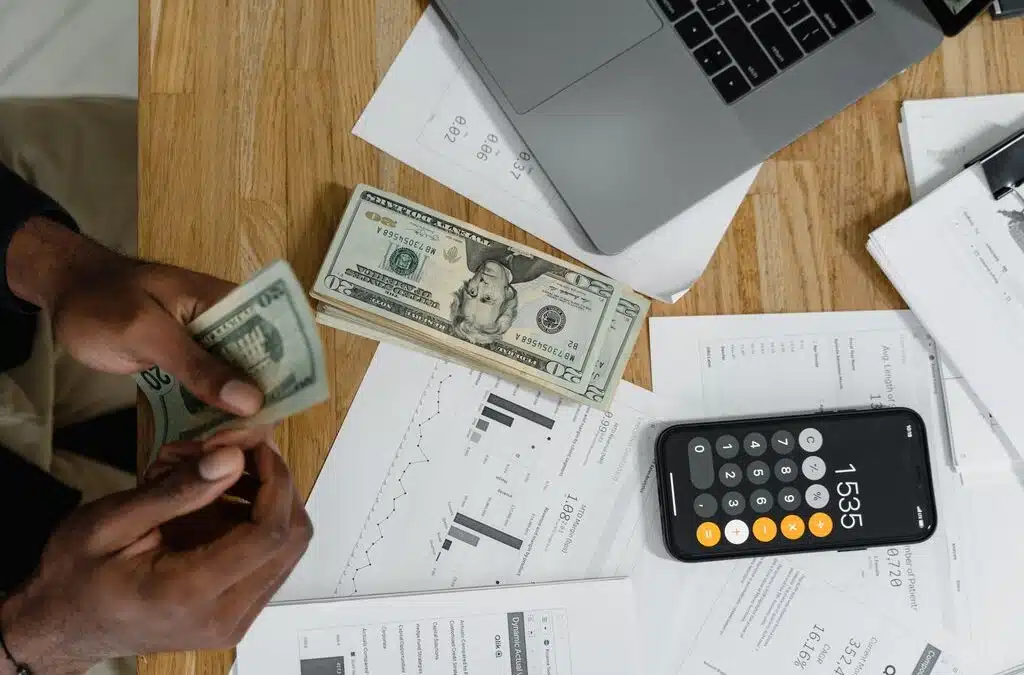 Money on a table with a calculator: how to calculate commercial cleaning costs
