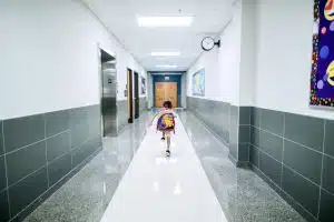 Little girl heading out of school for spring break: how to deep clean your school during spring break