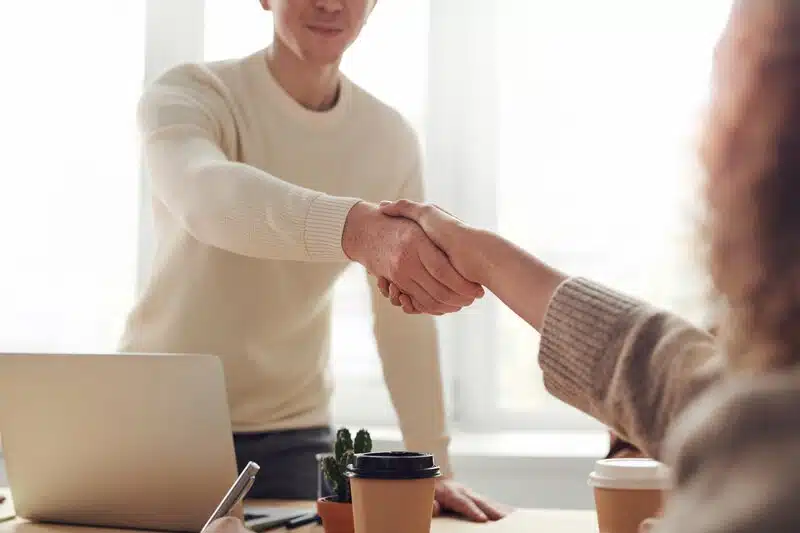Two people shaking hands on a business deal