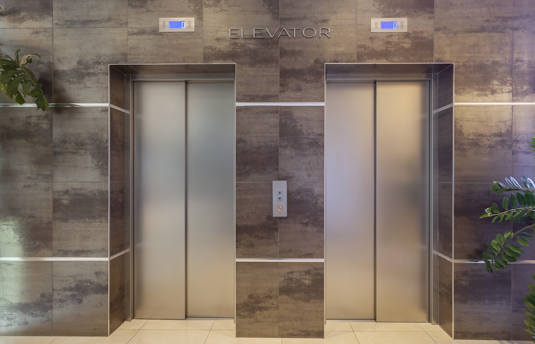Two elevators in a hotel lobby
